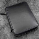 Black leather folio zippered pouch on white background
