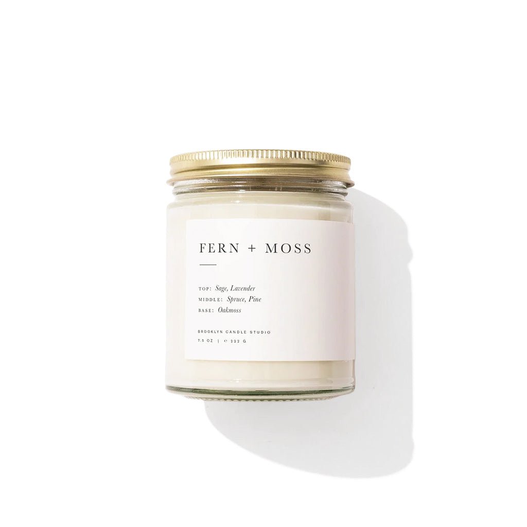 Fern + Moss candle with a white label on a white background