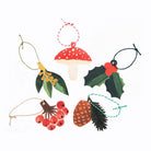 Set of Christmas-themed gift tags including a mushroom, holly, pine cone, and berries on a white background.