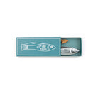A novelty fish-shaped knife in a silver finish, presented inside its teal matchbox packaging with a white fish illustration on the lid.
