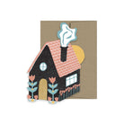 Folk-style house card with black home, flowers, and a chimney with smoke, paired with a kraft envelope.