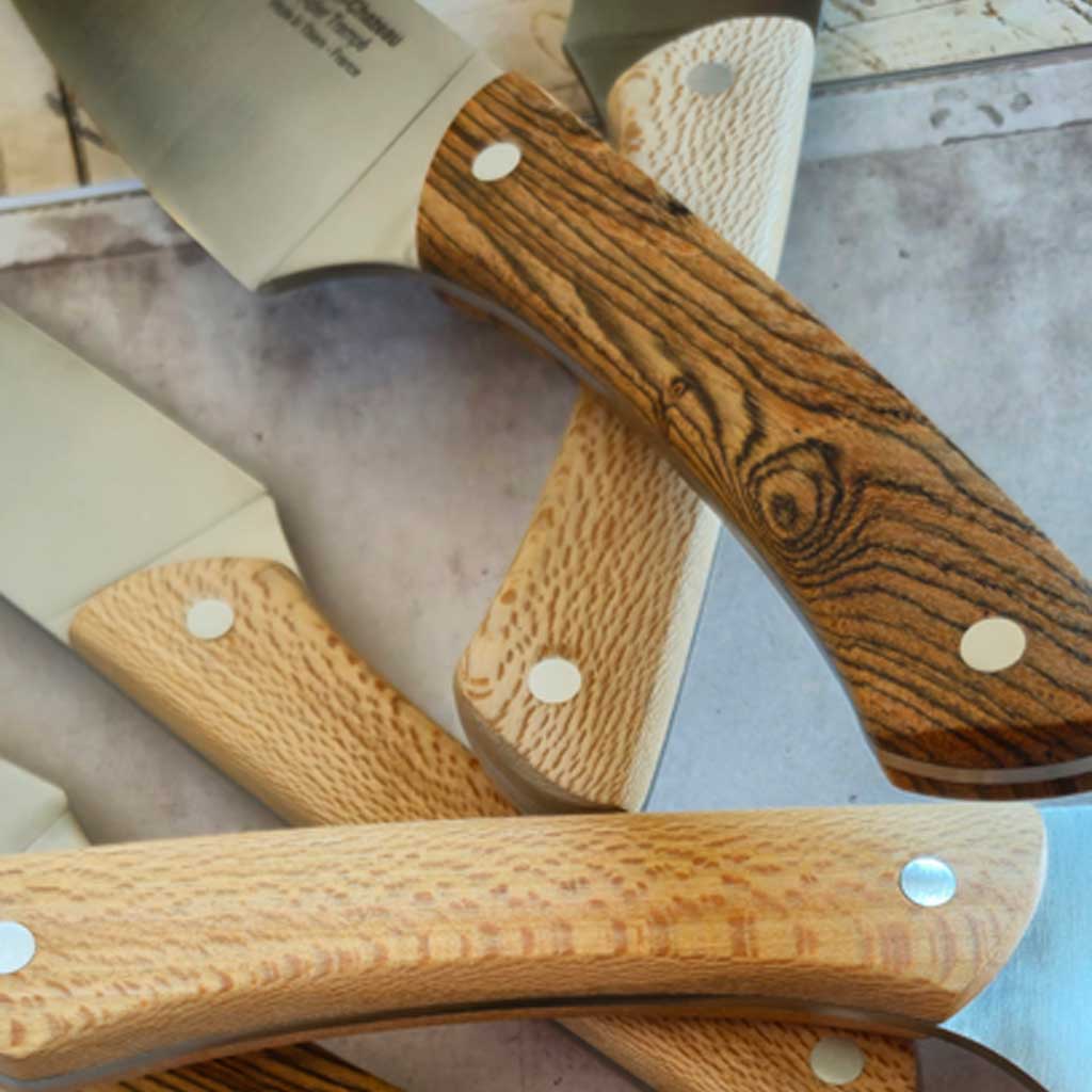 Close-up of two-toned jennywood handled knives on light background