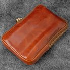Brown leather zippered pen case on gray background