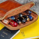 Brown leather case with pens on a yellow and black background