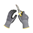 Gray gloves with yellow accents holding a pair of shears on a white background