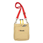 Beige canvas garden pouch with red strap and Niwaki branding with garden tools inside on white background
