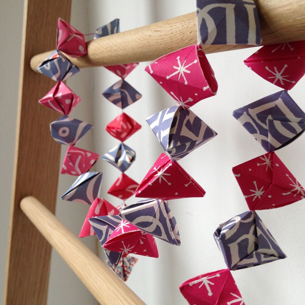 Cambridge Imprint Garland of Bobbles Origami Kit hung on ladder