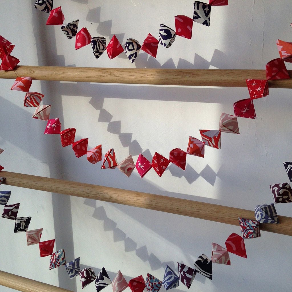 Cambridge Imprint Garland of Bobbles Origami Kit hung on ladder