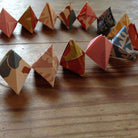 Colorful origami baubles arranged on a wooden surface