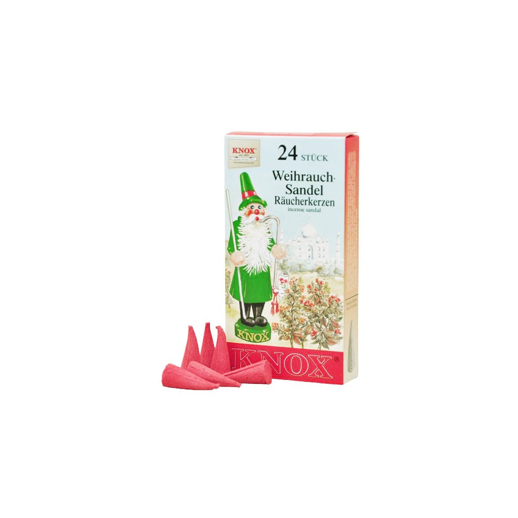 Box of KNOX sandalwood incense next to red incense cones on white background