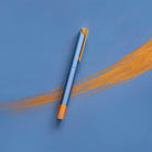 Pen with gold accents on a blue background