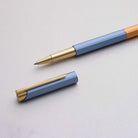 Pen with blue and gold design on a light gray background