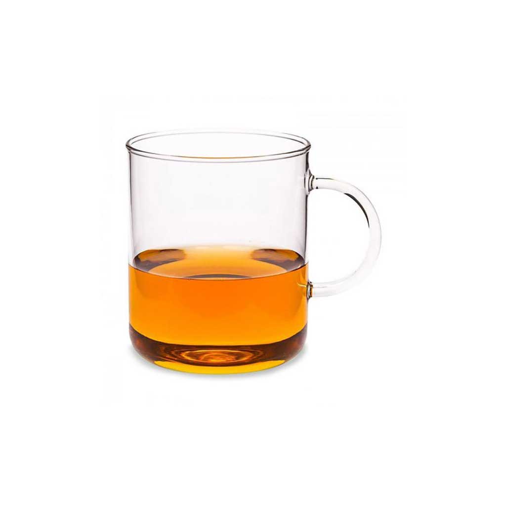 Clear glass mug with amber liquid on a white background