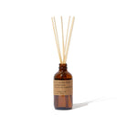 Amber glass diffuser bottle with wooden sticks on a white background