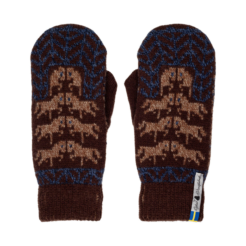 A pair of dark brown knit mittens with blue and tan patterns, featuring a stylized animal motif on the back of the hand and ribbed cuffs, shown against a plain white background.