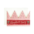A Christmas-themed greeting card featuring a pink crown with green pine tree patterns and a red banner reading 'Christmas Fairy' in white script, shown with a white envelope on a white background.