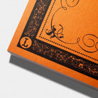 An orange Hand Lettering Guide Sheets pad on white background