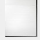 A white lined notepad with a subtle diagonal grid pattern, shown against a light gray background.