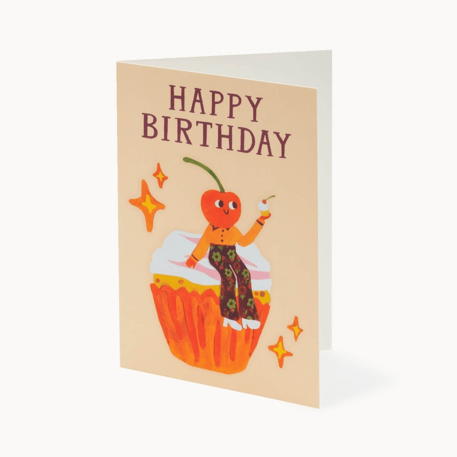 Birthday card with a cartoon character on a cupcake and 'Happy Birthday' text.