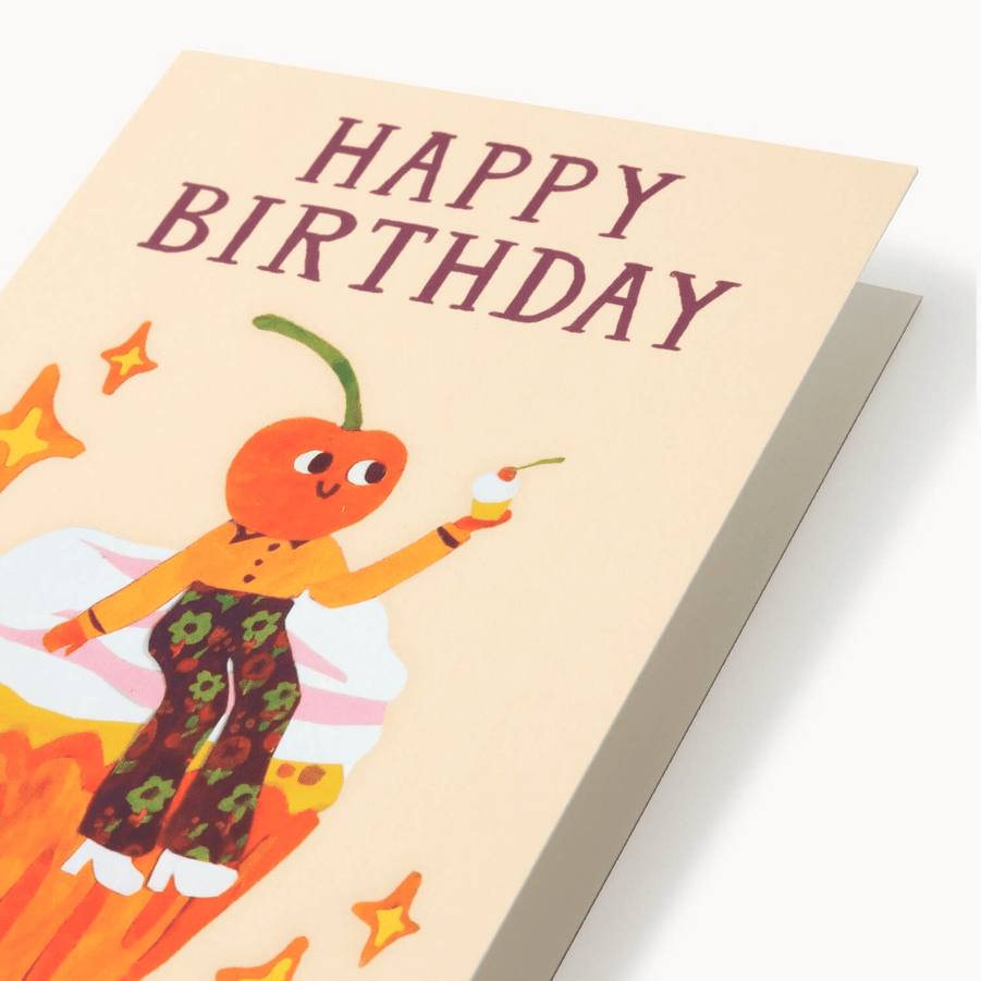 Birthday card with a cartoon character holding a cupcake and 'Happy Birthday' text on a light cream background.