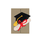 Graduation-themed greeting card with cap, tassel, and diploma on a beige background