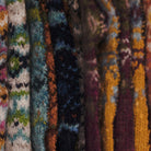 Close-up of various textured knitted wool fabrics in multicolors.