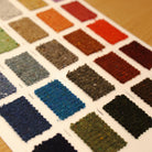 Swatches of various colors of wool yarns.