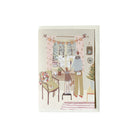 Holiday card with living room illustration and envelope on white background.