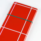 Clear Hobonichi Weeks clear cover with colorful dotted plaid pattern on red Weeks planner