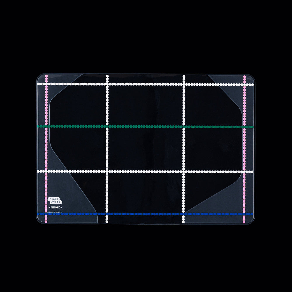 Clear cover for A6 Hobonichi Techo cover with colorful dotted plaid pattern against dark background
