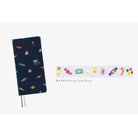 A dark navy blue hardcover notebook with a colorful candy print, shown alongside a matching horizontal strip of candy illustrations and the text 'Candy Dream'.