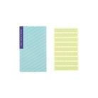 Set of double-sided tape strips next to blue booklet on white background