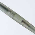 A close-up of a green-gray TSUKI no IRO rollerball pen with engraved branding and text, set against a clean white background.
