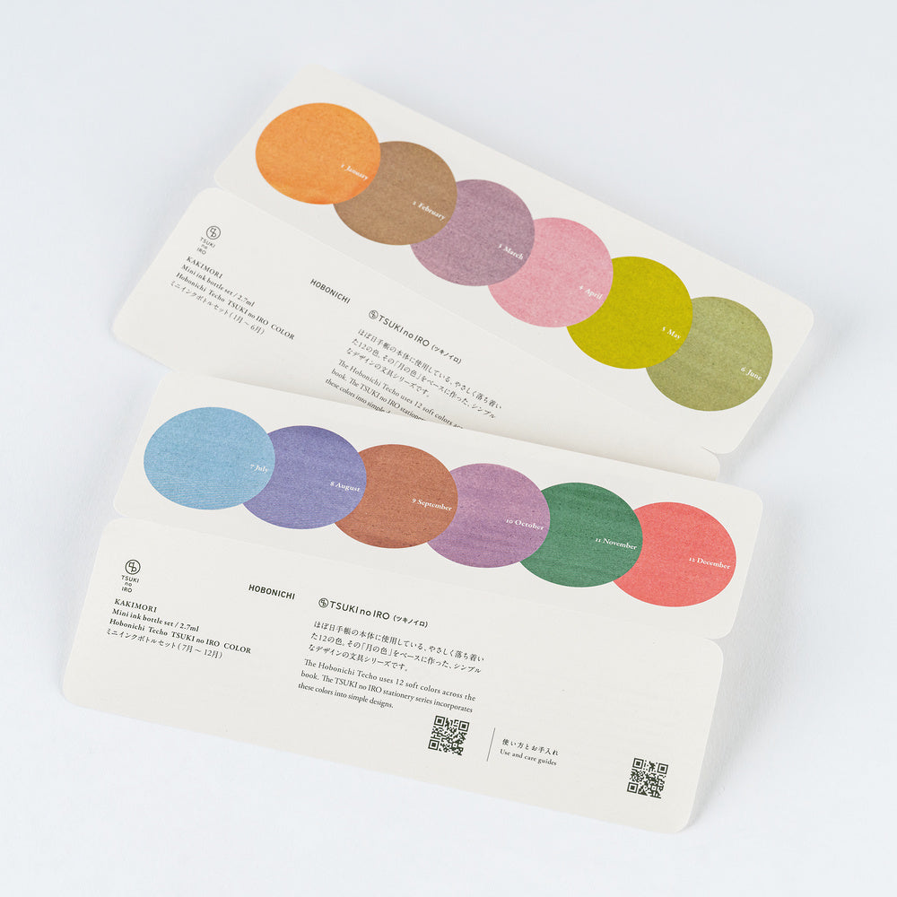 Two printed cards with circular color swatches and Japanese text, photographed on a clean white background.