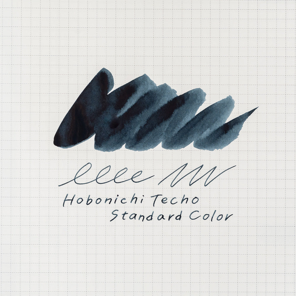 A dark blue-gray ink swatch on white graph paper, with the text 'Hobonichi Techo Standard Color' written below in dark script.