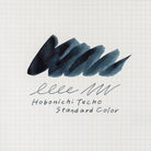A dark blue-gray ink swatch on white graph paper, with the text 'Hobonichi Techo Standard Color' written below in dark script.
