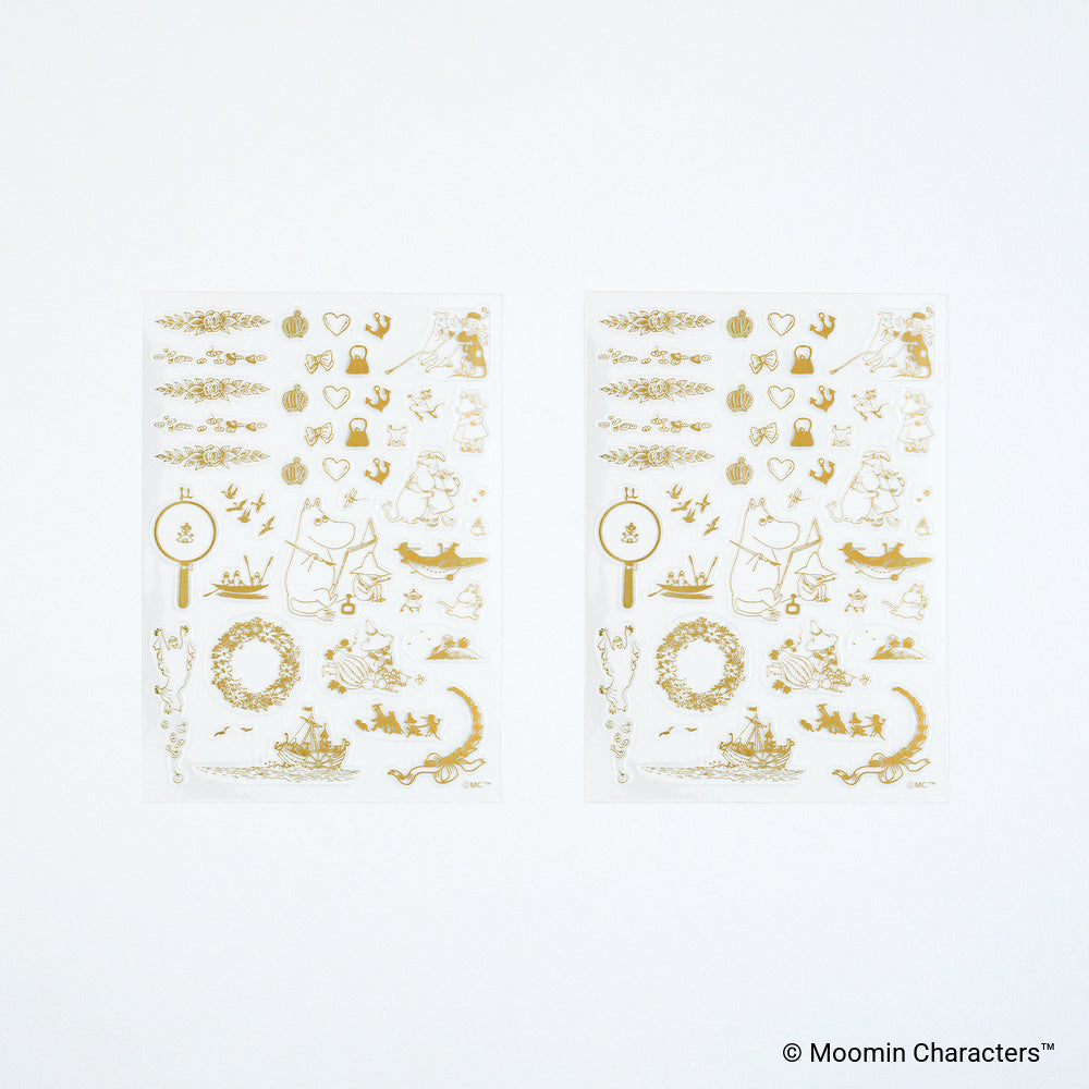Two sheets of gold foil stickers featuring Moomin Characters designs, displayed on a clean white background.