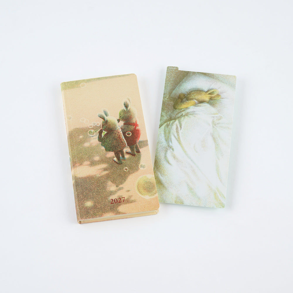 Akiko Miyakoshi pencil board next to 2027 Techo Weeks planner with rabbit illustrations.