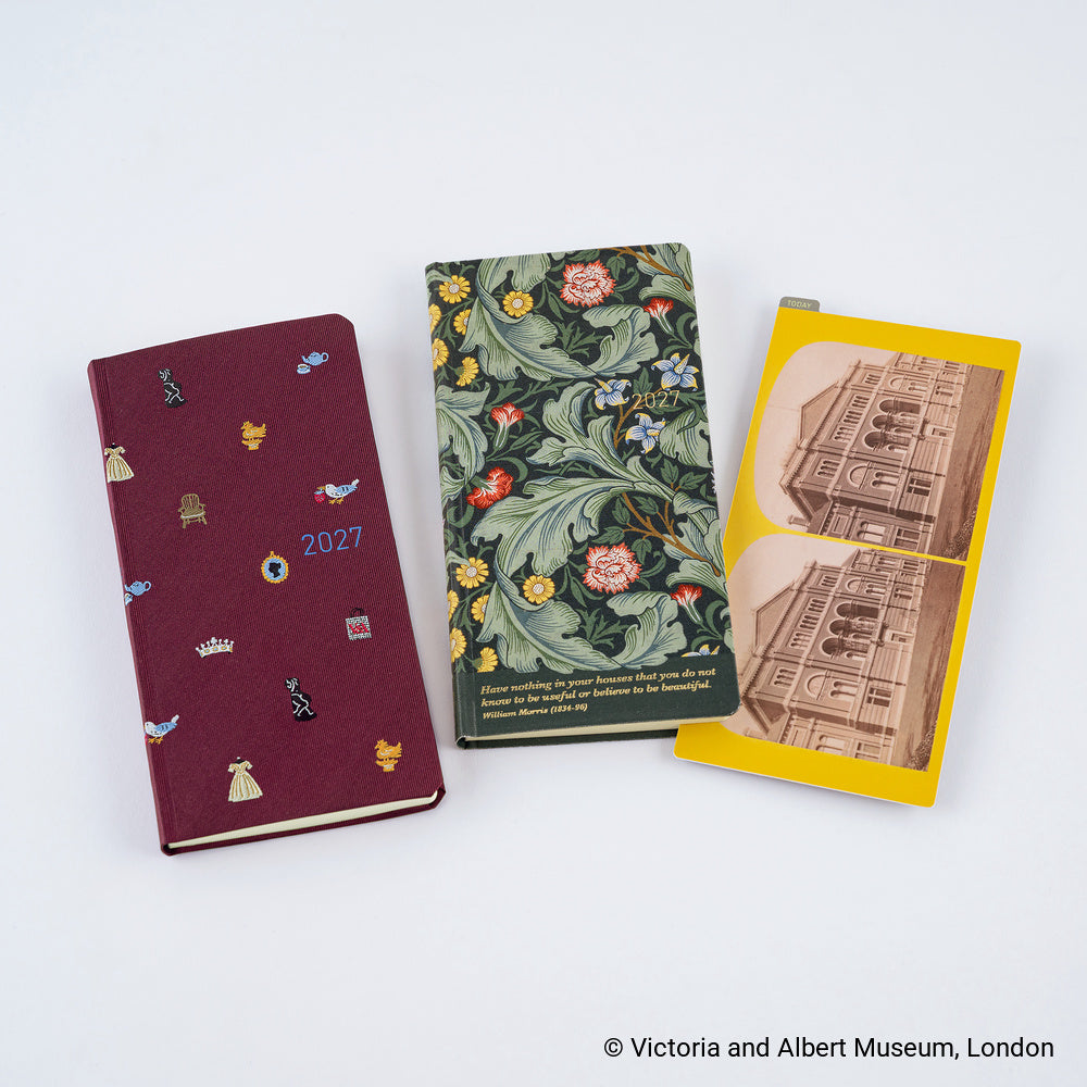 Two Techo Weeks planners, one with an embroidered maroon design, the other with a green botanical design and a pencil board tucked inside against a white background