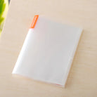 Clear photo album for A6 Hobonichi planner on wooden surface