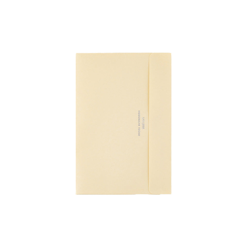 A6-sized cream pocket envelope for Hobonichi Techo on white background