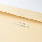 A close-up of a light beige paper envelope with the text 'LIFE BOOK' and 'HOBONICHI TECHO' printed in silver on the flap.