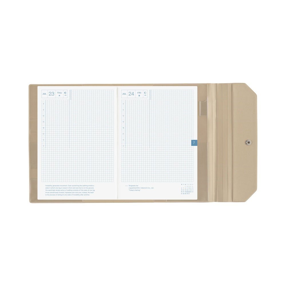 An open beige Hobonichi Alettone cover holding a gridded Hobonichi planner, with interior pockets, pen hook, and snap closure visible on a plain white background.