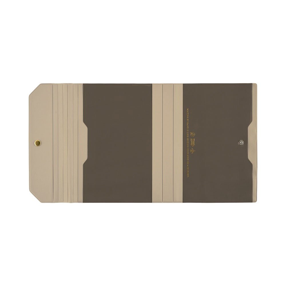 A flat view of a warm gray and taupe Hobonichi Techo Alettone planner cover with a tri-fold design, exterior pocket, and gold snap button on a plain white background.