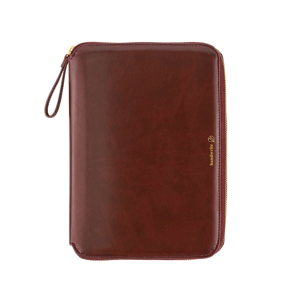 A deep wine-colored Hobonichi Techo zippered cover with a smooth finish, gold zipper, wrist loop, and gold 'handwrite' logo on a plain white background.
