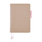 Greige colored Hobonichi Techo cover with contrast pink stitching, pink pen loops, and two pale pink ribbon bookmarks with tabs shown on a plain white background.