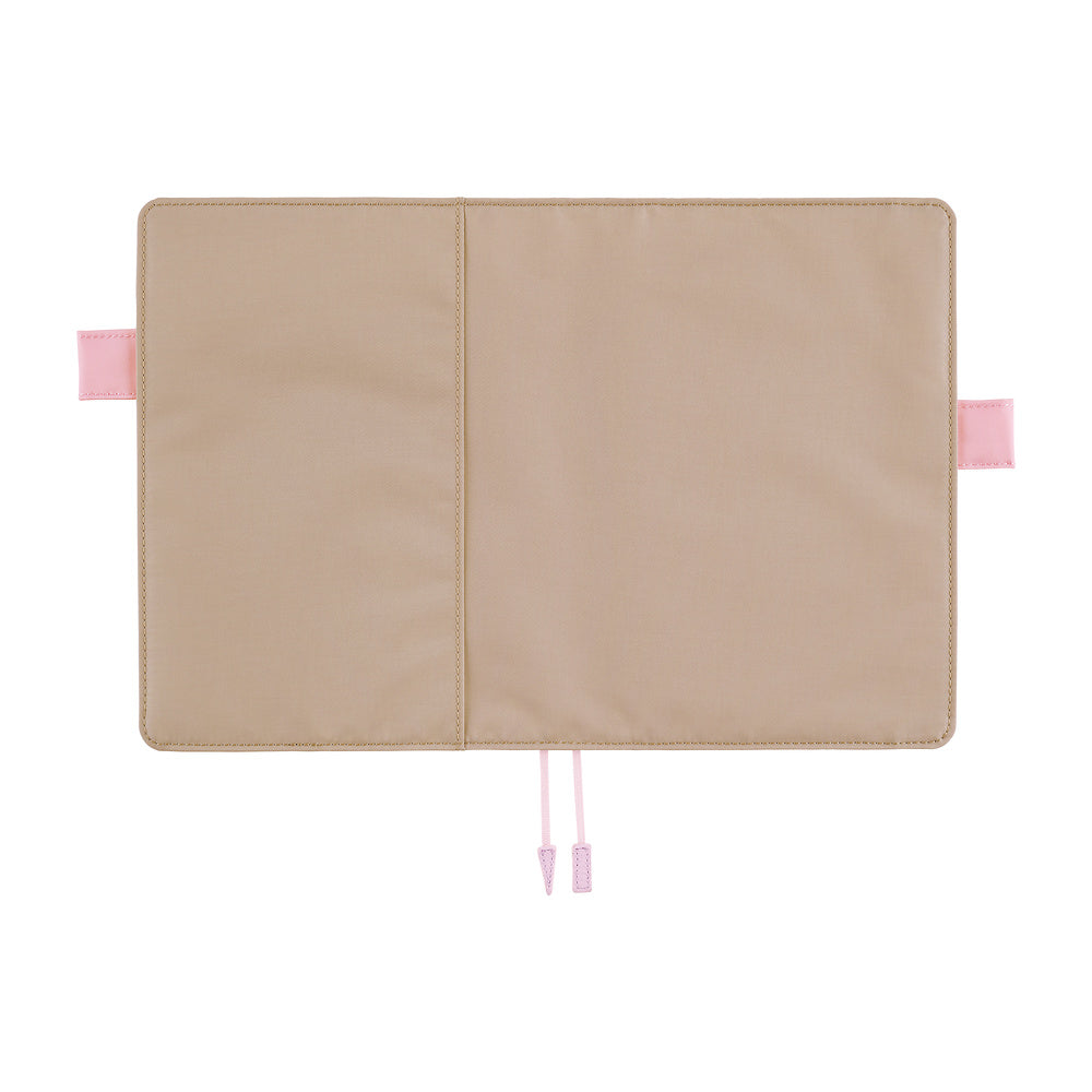 Greige Hobonichi Techo cover laid open flat on a white background, showing pink pen loops and two pale pink ribbon bookmarks.