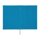 A blue Hobonichi Techo cover laying flat with a bright red bookmark ribbon and a small gold text on the spine, displayed flat against a white background.