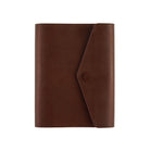 A brown leather Hobonichi Techo cover with a diagonal flap and snap button closure, shown against a plain white background.