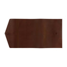 A dark brown leather Hobonichi Techo cover with a pointed triangular flap on the left and a small circular magnet sewn  into the right side, shown flat against a solid white background.